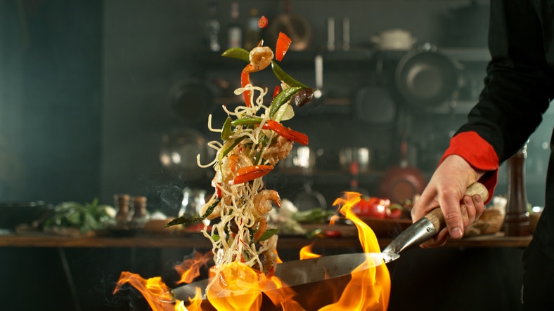 Freeze motion of flying asian wok noodles with prans and vegetable